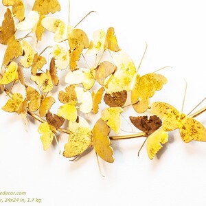 May include: Gold metal butterfly wall decor with 24x24 inches dimensions and weighs 1.7 kg. The butterflies are arranged in a circular pattern on a gold metal wire frame.