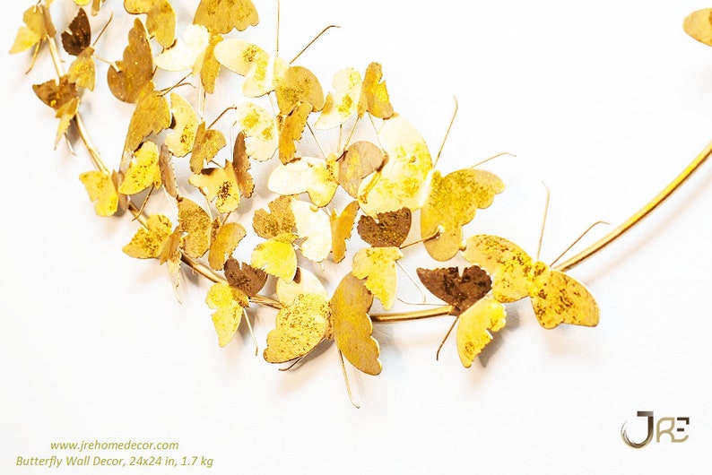 May include: Gold metal butterfly wall decor with 24x24 inches dimensions and weighs 1.7 kg. The butterflies are arranged in a circular pattern on a gold metal wire frame.