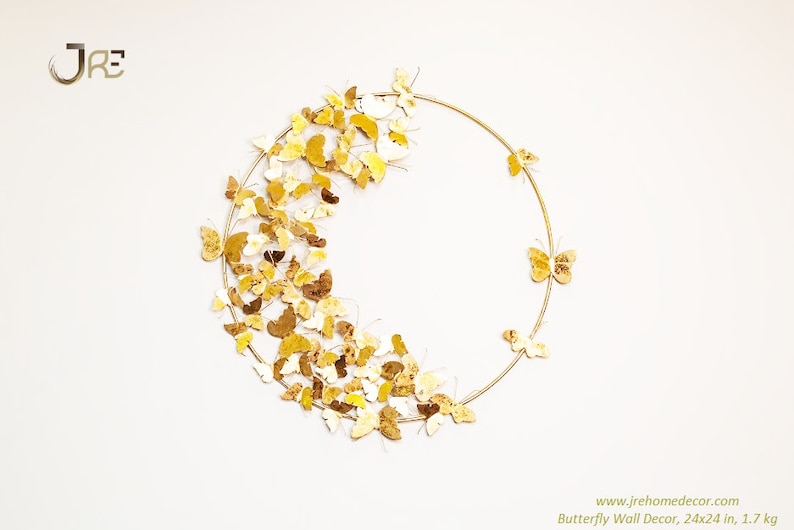 May include: Gold butterfly wall decor with a circular metal frame. The butterflies are arranged in a semi-circle around the frame. The decor measures 24x24 inches and weighs 1.7 kg.