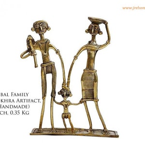 May include: A brass sculpture of a tribal family. The family consists of a man, a woman, and a child. The man is holding a stick, the woman is carrying a basket on her head, and the child is holding onto the woman's hand. The sculpture is 6 inches by 3.5 inches and weighs 0.35 kg.