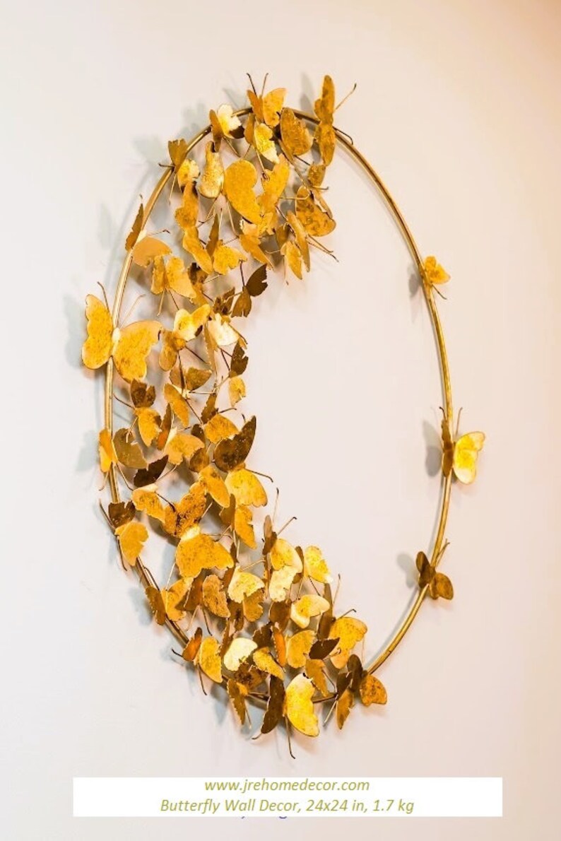 May include: Gold metal butterfly wall decor with a circular frame. The butterflies are arranged in a cascading pattern around the frame. The decor measures 24x24 inches and weighs 1.7 kg.