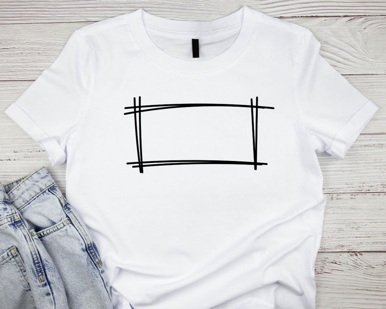 May include: White t-shirt with a black outlined rectangle design.