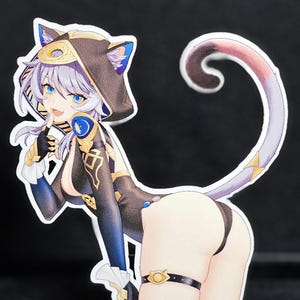 May include: A die-cut sticker featuring a stylized anime character with cat ears and a long, curved tail. The character wears a black and gold outfit with blue accents. The sticker has a black background.