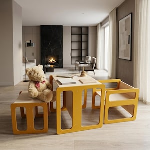May include: A contemporary children's table and chair set. The set includes a rectangular table and two chairs with a bright yellow frame and natural wood surfaces. A teddy bear sits on the bench. The set is in a well-lit room.
