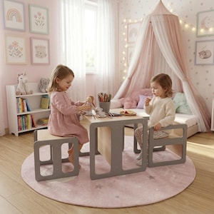 May include: A children's play table and two matching chairs in a light wood and gray color scheme. The table has a rectangular top and a gray frame. The chairs are small, square, and gray. The scene is set in a child's bedroom.