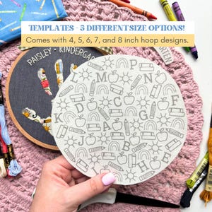 May include: A circular white fabric template featuring a repeating pattern of gray line art icons including letters, pencils, apples, rainbows, and books. The text reads: TEMPLATES - 5 DIFFERENT SIZE OPTIONS! Comes with 4, 5, 6, 7, and 8 inch hoop designs.