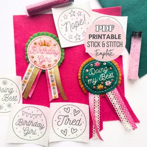 May include: A selection of craft materials, including felt, ribbons, and embellishments. Two embroidered badges are visible, reading "Birthday Girl" and "Doing my Best". Printed templates and glitter tubes are also present.