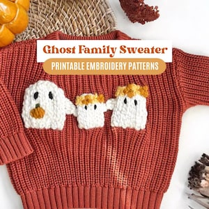 May include: A red knitted sweater with three white ghost appliques. The ghosts have black eyes and mouths, and the largest ghost has a small orange pumpkin applique. The sweater has the text "Ghost Family Sweater" and "Printable Embroidery Patterns" on it.