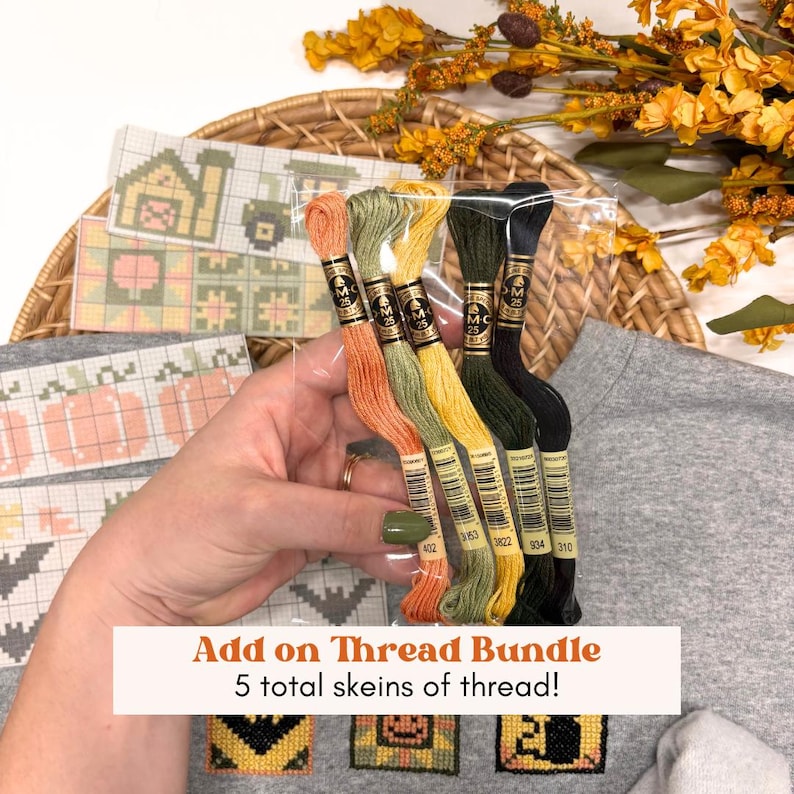 May include: A bundle of five embroidery thread skeins in orange, light green, yellow, dark green, and black, packaged in clear plastic. The skeins feature labels with the text DMC 25 and specific color codes, held together for cross-stitch projects.