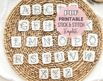 May include: A set of white square fabric patches featuring the alphabet from A to Z in gray embroidery-style font, each letter accented with a small bow graphic. A pink circular overlay displays the text PDF PRINTABLE STICK & STITCH Template.