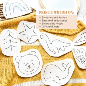 May include: A set of eight printable and stitchable designs featuring a rainbow, star, tree, dinosaur, bear, whale, lightning bolt, and butterfly. The designs are printed on white paper and are ready to be cut out and stitched onto fabric.