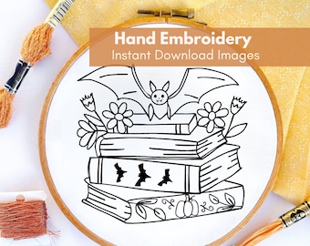 May include: Black and white line art embroidery pattern of a bat perched on a stack of books with flowers and pumpkins. The pattern is in a wooden embroidery hoop. "Hand Embroidery Instant Download Images" is written in orange text at the top of the image.