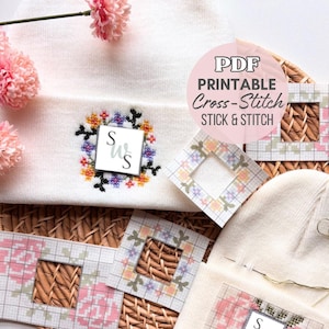 Könnte beinhalten: Eine weiße Strickmütze mit einem bunten Blumen-Kreuzstichmuster und den Buchstaben S und W in der Mitte. Mehrere quadratische Papiervorlagen mit Gittermustern und Blumendesigns sind neben der Mütze abgebildet. Der Text lautet PDF PRINTABLE Cross-Stitch STICK & STITCH.