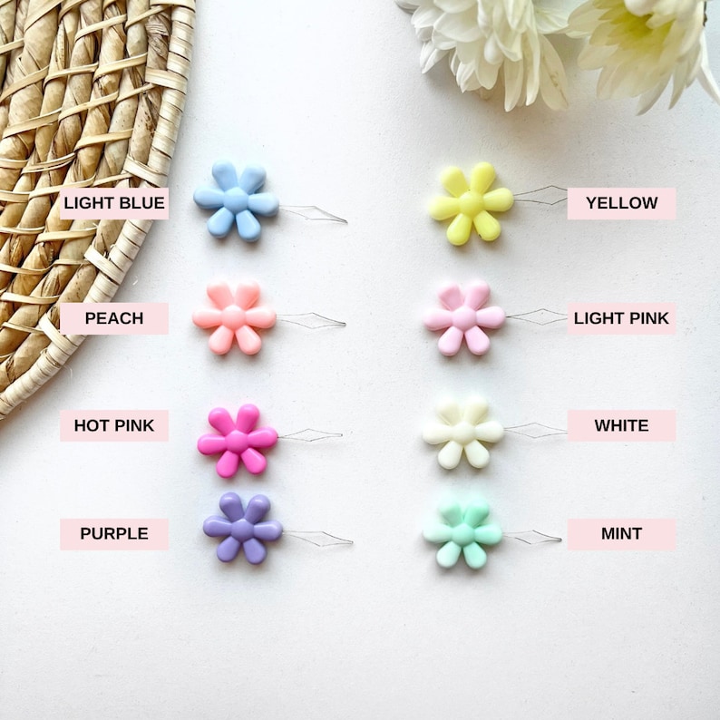 May include: Assortment of ten colorful daisy-shaped threaders in light blue, yellow, peach, light pink, hot pink, white, purple, and mint.