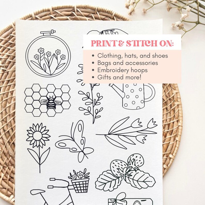 May include: A white sheet featuring black line art illustrations of nature motifs including an embroidery hoop with flowers, a bee on a honeycomb, a sunflower, a butterfly, a watering can, and strawberries. Text reads: PRINT & STITCH ON: Clothing, hats, and shoes, Bags and accessories, Embroidery hoops, Gifts and more!