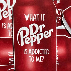 May include: A red can with the words "What if Dr Pepper is addicted to me?" printed on it. The can is a sticker with a glossy finish.