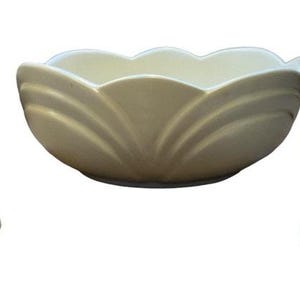 Puede incluir: Un juego de tres cuencos de cerámica blanca con un diseño floral. Los cuencos tienen forma de flor, con un cuenco ancho y poco profundo y una base estrecha.