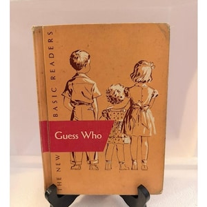 May include: A vintage hardcover book titled The New Basic Readers Guess Who with a tan cover featuring a brown line drawing of three children standing together. The title text is printed in black and white on a red horizontal banner across the front.