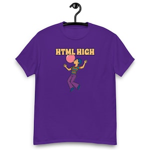 May include: A purple t-shirt with the text "HTML HIGH" in orange. The design shows a cartoon person blowing a pink bubble. The person is wearing a striped top, purple trousers, and blue shoes. The t-shirt is hanging from a black hanger.