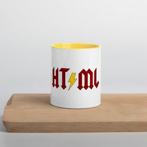 May include: White ceramic mug with a yellow rim. The mug features a red and yellow graphic that says "HT-ML" with a lightning bolt in between the letters.
