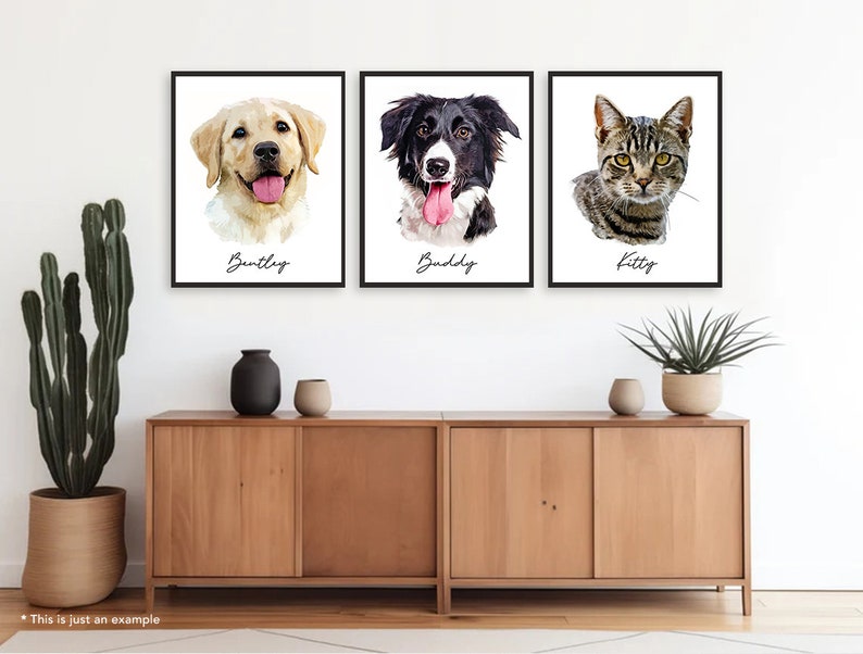 May include: Three framed pet portraits on a white wall above a wooden cabinet. The portraits feature a golden retriever named Bentley, a black and white border collie named Buddy, and a tabby cat named Kitty.