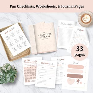 May include: A collection of gratitude journals and worksheets. The image shows a journal, stickers, and various pages with prompts and checklists. The color scheme is soft, with beige, pink, and brown tones. A cup of coffee sits in the upper right corner.