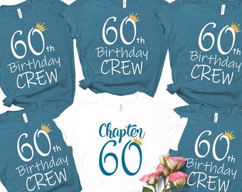 May include: Five teal blue t-shirts with white text and gold crowns. The text on the shirts reads "60th Birthday Crew" and "Chapter 60".