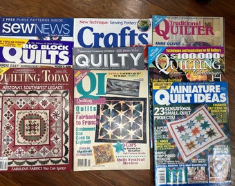 May include: A collection of quilting magazines with colorful covers. Titles include "Quilting Today," "Quilts," "Miniature Quilt Ideas," and "Traditional Quilter." The magazines feature quilting patterns, techniques, and inspiration for quilters.