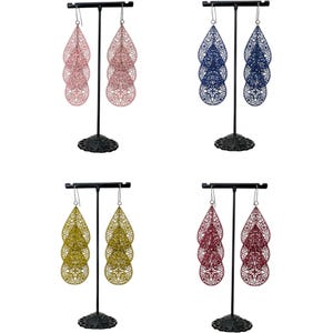 May include: Four pairs of filigree teardrop earrings in pink, navy blue, gold, and burgundy. Each pair is displayed on a black metal earring stand. The earrings have a layered design with intricate cut-out patterns.