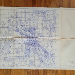 May include: A black and white map of a city with blue lines showing the roads and waterways. The map is titled "Terminal Instrument Procedures, Detroit, Lake County Airport, Michigan Lake Huron Section".