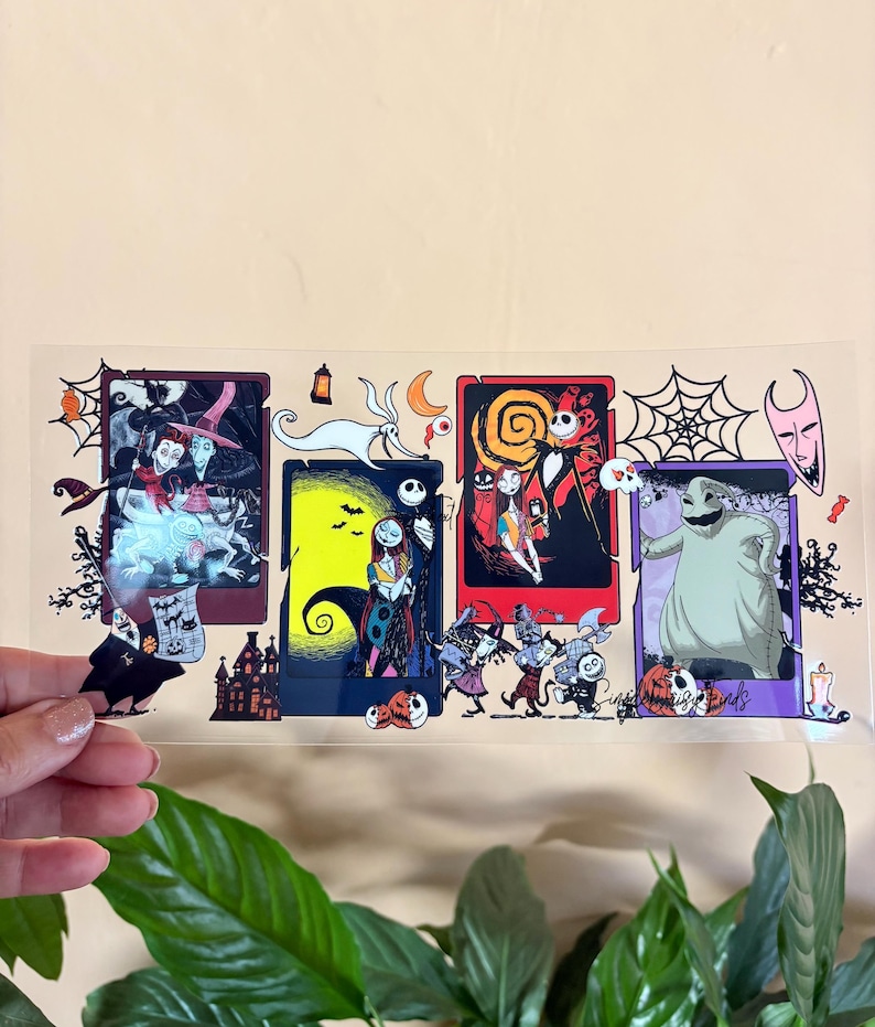 May include: A clear sticker featuring four rectangular panels with characters from The Nightmare Before Christmas. Each panel has a different scene with characters like Jack Skellington, Sally, and Oogie Boogie. The sticker has a light beige background.