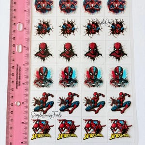 May include: A sheet of Spider-Man stickers with multiple designs. The stickers show the superhero in action and close-ups of his mask. The sheet includes the text "Spider-Man" in a red and yellow design. A pink ruler is on the left.
