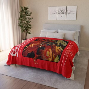 May include: Red fleece blanket featuring a Dungeons & Dragons illustration of a red dragon and a knight. The blanket includes the text "Fantasy Role-Playing Game" and the Dungeons & Dragons logo.