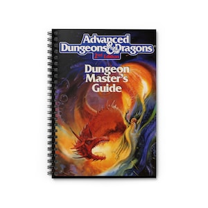 May include: A spiral bound notebook with a cover featuring a fantasy illustration of a red dragon breathing fire and a wizard in a blue robe. The cover text reads "Advanced Dungeons & Dragons 2nd Edition Dungeon Master's Guide".