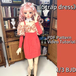 May include: A red strap dress with a floral patterned bodice and long sleeves is displayed on a doll. The text "Strap dress", "PDF Pattern Video Tutorial", and "1/3 BJD" are visible.