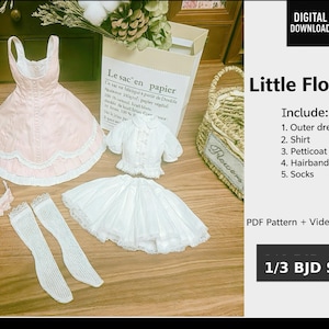 May include: A doll clothing set, including a pink outer dress, white shirt, petticoat, headband, and socks. The set is designed for a 1/3 BJD doll. The image also includes text that says "Little Flower" and "Digital Download".