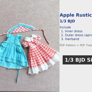 May include: Two doll dresses and a headband are displayed. One dress is light blue with pockets and a ruffled hem. The other is red and white gingham with a white collar and hem. The headband is red and white gingham. Text on the right says "Apple Rustic 1/3 BJD".