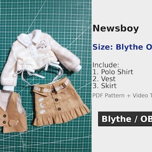 May include: A miniature doll outfit, including a polo shirt, vest, and skirt. The outfit is beige and white, with a small bear graphic on the shirt and vest. The text "Newsboy" and "Blythe OB24" are also visible.