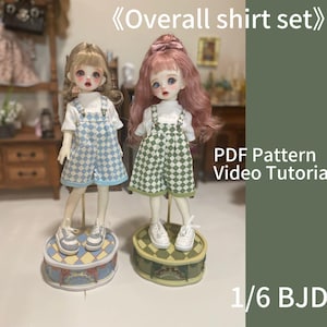 May include: Two dolls wearing checkered overalls and white shirts. The doll on the left is wearing blue and white checkered overalls, and the doll on the right is wearing green and white checkered overalls. Both dolls are standing on decorative stands. The text "Overall shirt set" is at the top of the image, and the text "PDF Pattern Video Tutorial 1/6 BJD" is at the bottom of the image.
