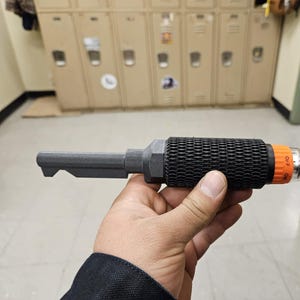 May include: A black and orange key with a textured grip and a switch labeled "OFF ON".