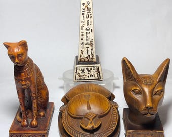 Estatua del antiguo Egipto: gato Bastet, escarabajo y obelisco decorativo de piedras pesadas. Hecho en Egipto.