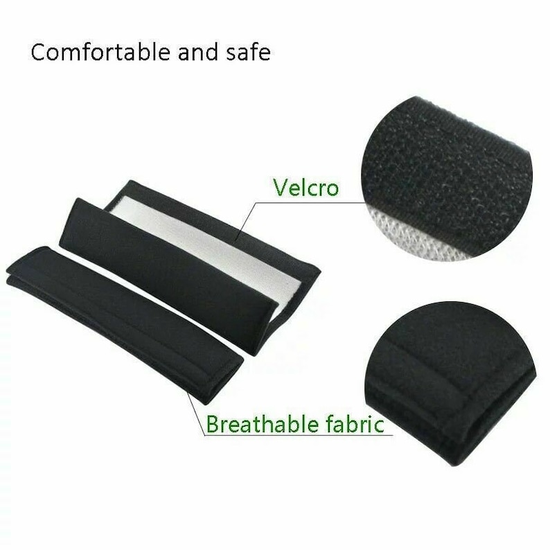 May include: Two black seat belt pads with a white lining and velcro closures. The pads are made of breathable fabric and are designed to provide comfort and safety.