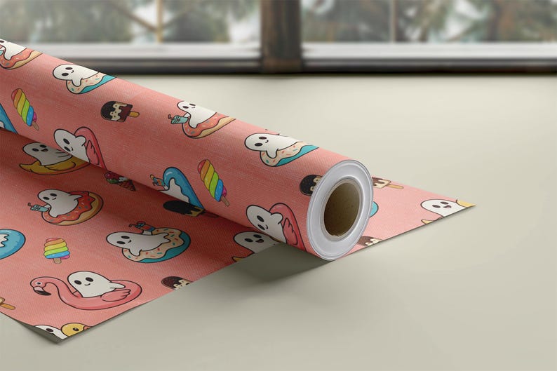 May include: A roll of wrapping paper with a salmon-pink background featuring a repeating pattern of white cartoon ghosts, colorful rainbow popsicles, chocolate-dipped ice cream bars, and ghosts floating in pink flamingo pool floats.