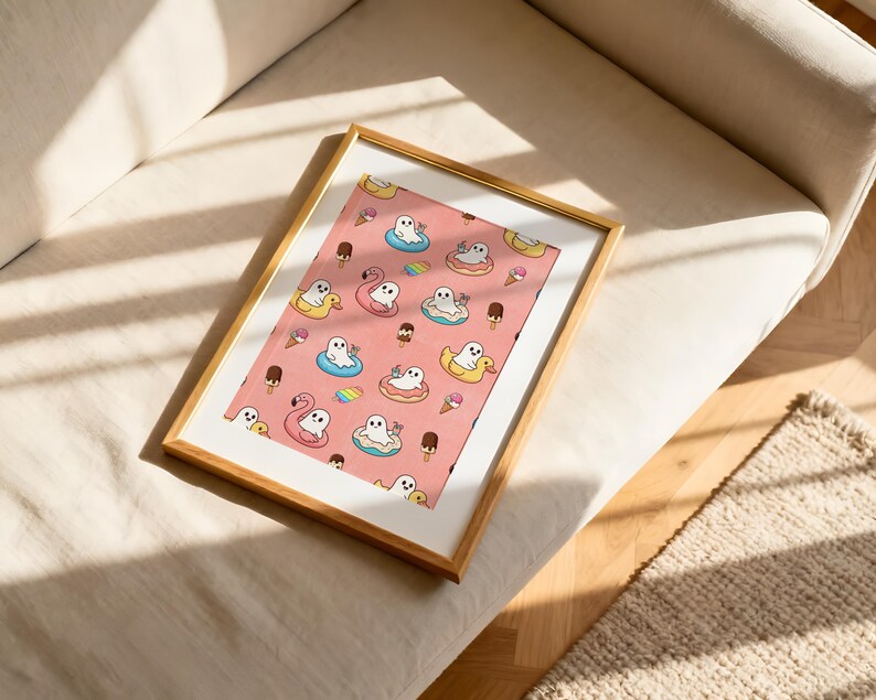 May include: A rectangular wall art print in a gold frame featuring a repeating pattern on a pink background. The design includes white ghosts floating in colorful pool floats, pink flamingo floats, yellow duck floats, ice cream cones, and popsicles.