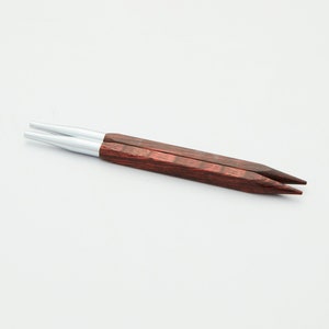 May include: A pair of red wood knitting needles with silver tips.