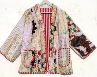 May include: A white quilted jacket with a red and white striped lining. The jacket has a patchwork design with colorful floral embroidery and a large floral design on the right sleeve.