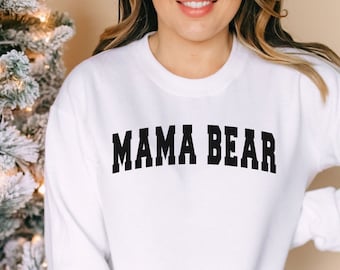 May include: White sweatshirt with black text that reads "MAMA BEAR" in a bold font.