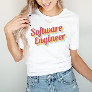 May include: A white t-shirt with the text "Software Engineer" in a retro, multi-coloured font.