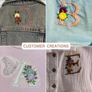 May include: A collage of four garments featuring custom embroidery. Top left: a denim jacket with a pink letter Q and floral accents. Top right: a light blue fabric with a tan letter B and flowers. Bottom left: a pink shirt with a butterfly and letter A. Bottom right: a white button-down shirt with a brown letter E and floral details. The text CUSTOMER CREATIONS is centered.