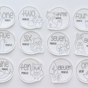 May include: Black and white printable baby milestone cards featuring woodland animals and the numbers one through twelve. The cards are designed to be used for monthly baby photos.